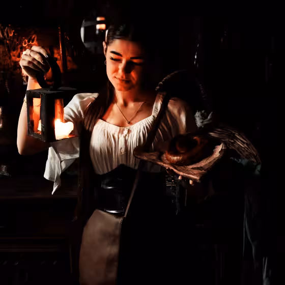 a ukrainian girl wearing traditional clothes prepares to serve diners in the 5th. dungeon restaurant lviv